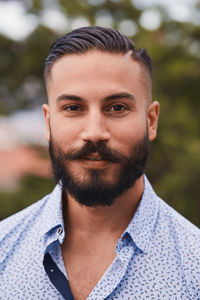 Portrait of confident bearded man at party