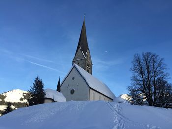 Low angle view of traditional building against sky during winter
