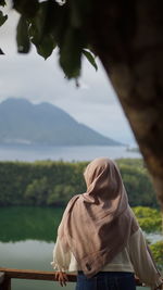 Low angle view of woman standing against sky