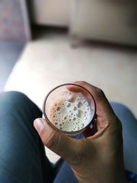 Cropped hand holding coffee