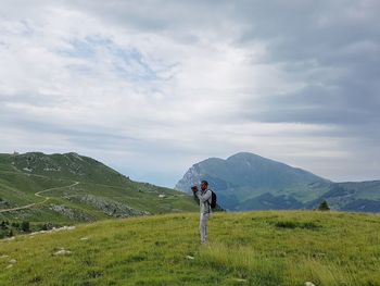 Man standing on mountain against sky