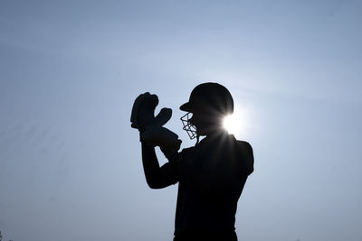 Silhouette woman photographing against clear sky during sunset