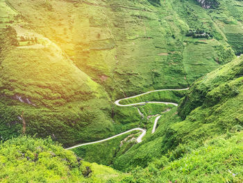 High angle view of winding road amidst rice terrain