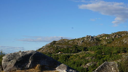 Scenic view of mountain by sea against sky