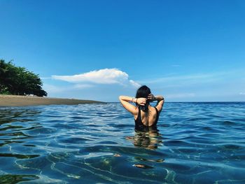 Rear view of woman in sea