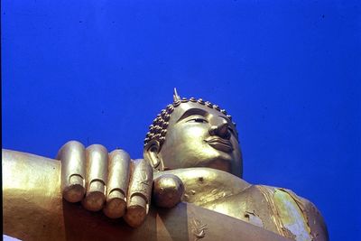 Close-up of statue against blue sky