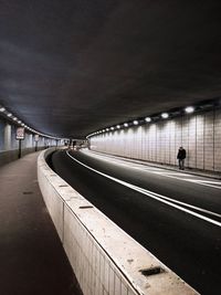 Man on illuminated road in city