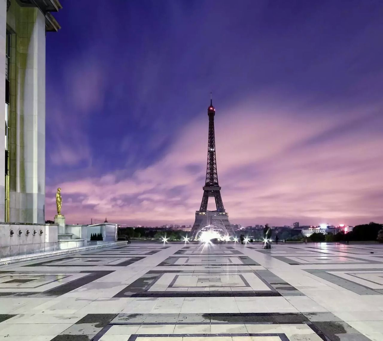 architecture, built structure, sky, famous place, tower, international landmark, eiffel tower, travel destinations, tourism, cloud - sky, capital cities, building exterior, tall - high, travel, cloudy, culture, city, communications tower, cloud, metal