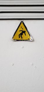Close-up of warning sign on wall