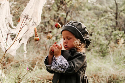 Full length of boy holding apple on land