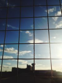 Low angle view of sky seen through fence