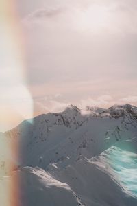 Scenic view of snowcapped mountains against sky during sunset