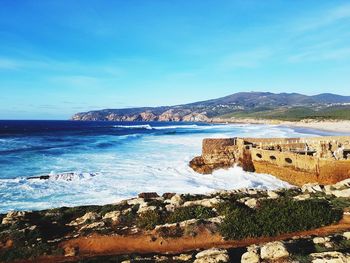 Scenic view of sea against blue sky