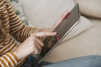 Close-up of woman using digital tablet