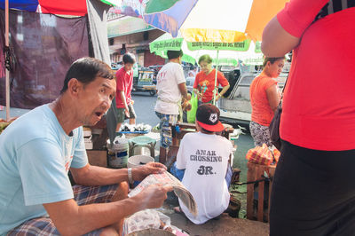 People working at market stall