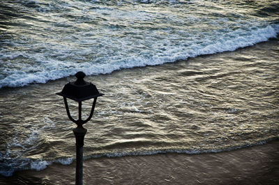 High angle view of lamp post by sea