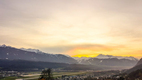 Scenic view of snowcapped mountains against sky during sunset