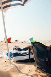 Boat moored on beach against clear sky