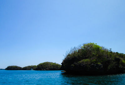 Scenic view of sea against clear blue sky