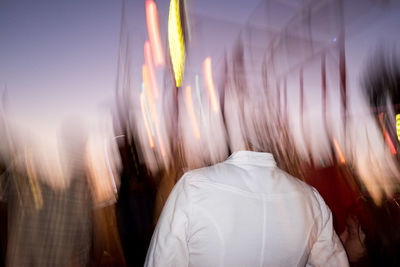 Decapitated man standing against sky