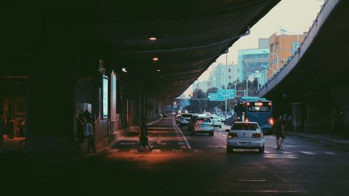 Cars on road amidst buildings in city