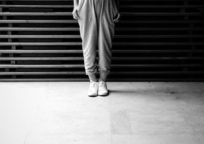 Low section of woman standing on tiled floor