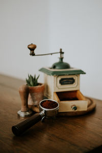 Close-up of coffee on table against wall