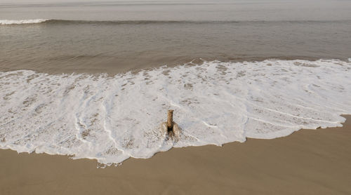 High angle view of surf on beach