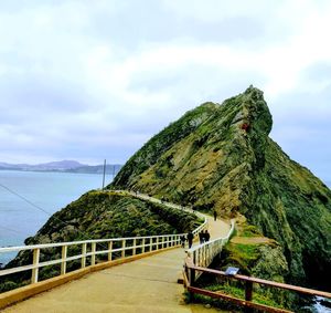 Scenic view of sea and mountains against sky