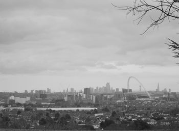 View of buildings in city against cloudy sky