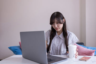 Businesswoman using laptop at home