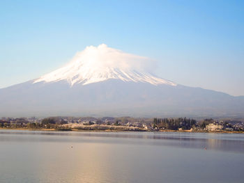 Scenic view of lake and mountains against sky