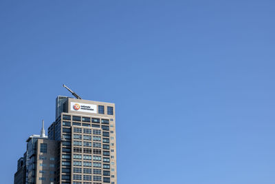 Low angle view of building against clear blue sky