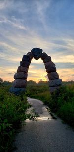 Rock formation amidst rocks against sky during sunset