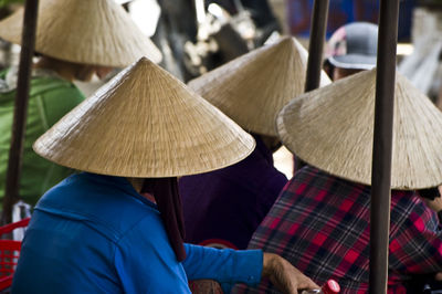 Rear view of people wearing asian style conical hat