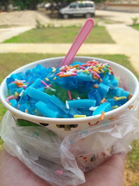 Close-up of hand holding ice cream