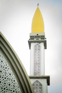 Low angle view of muslim traditional building, minaret against sky.