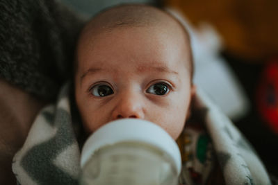 Cute baby boy drinking milk