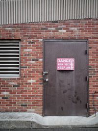 Close-up of text on brick wall