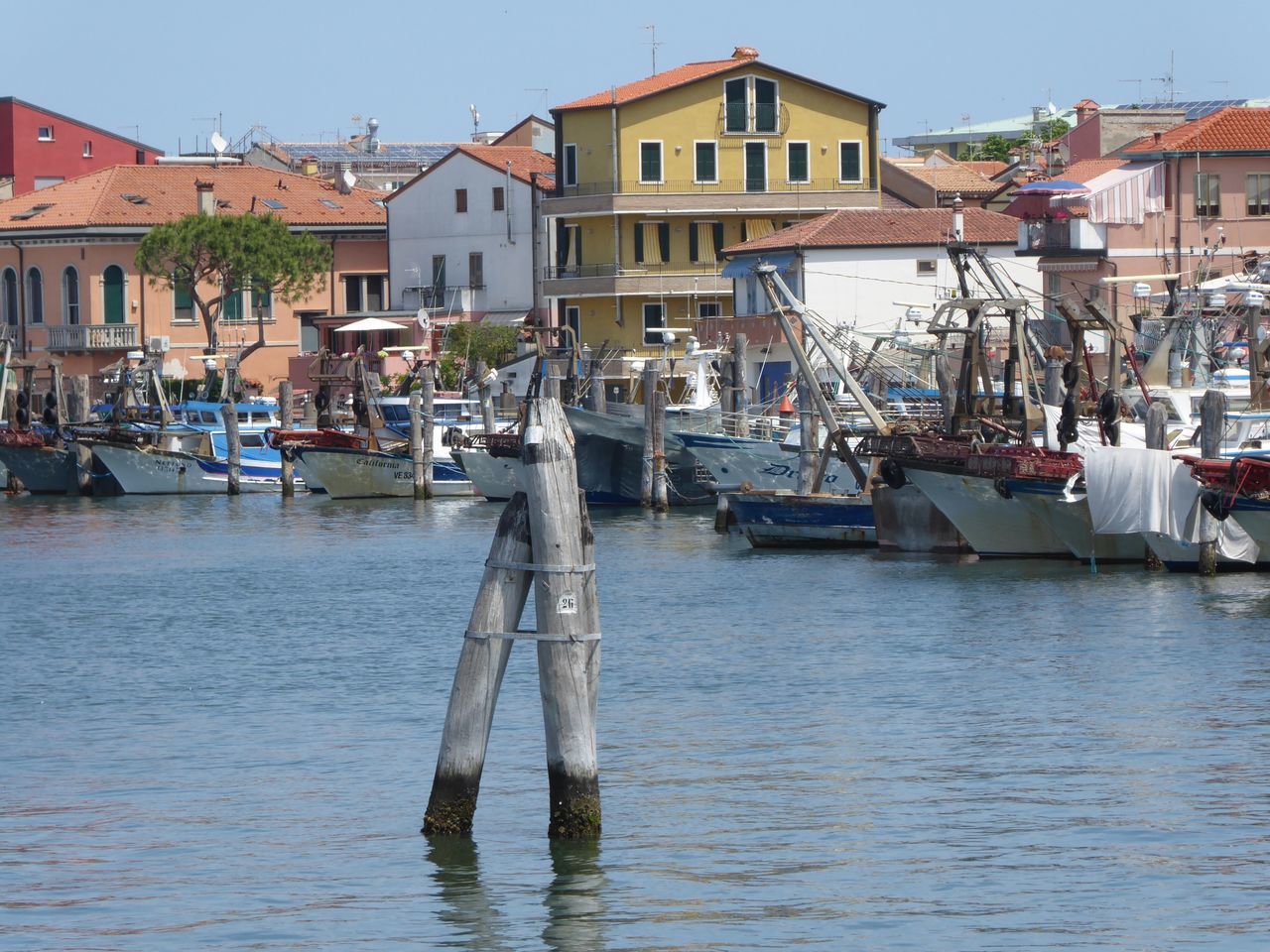 nautical vessel, water, architecture, building exterior, built structure, mode of transportation, transportation, moored, harbor, sailboat, nature, waterfront, building, residential district, day, city, sky, pole, no people, outdoors, canal, wooden post, yacht, fishing industry