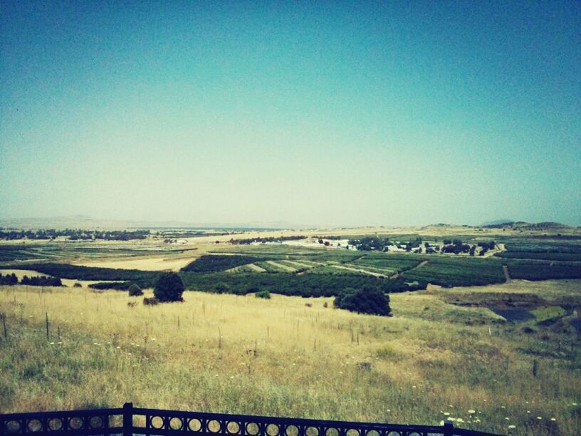 clear sky, copy space, landscape, blue, field, tranquil scene, tranquility, nature, scenics, horizon over land, day, beauty in nature, outdoors, rural scene, no people, non-urban scene, remote, agriculture, sky, sunlight