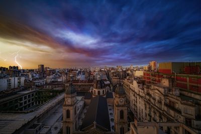 High angle view of buildings against cloudy sky