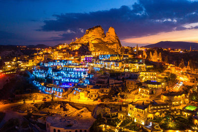 Illuminated townscape against sky during sunset