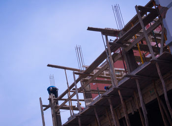 Low angle view of crane against clear sky