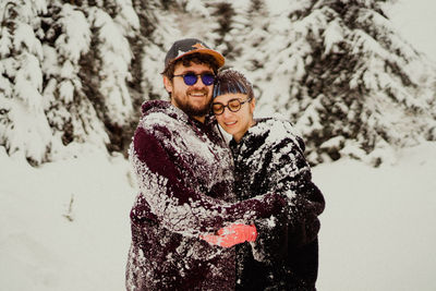 Smiling couple standing outdoors during winter
