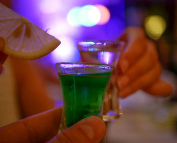 Close-up of hand holding beer glass
