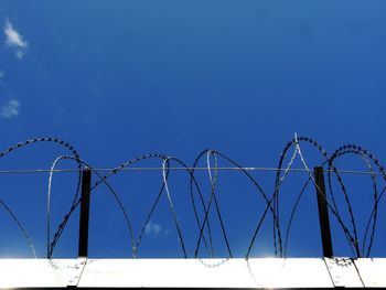 View of fence against blue sky