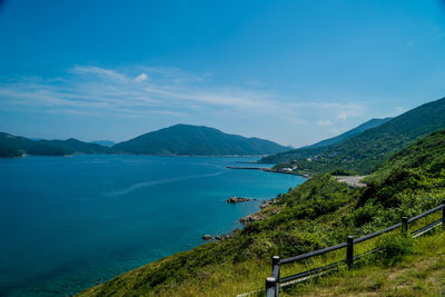 Scenic view of sea and mountains against sky