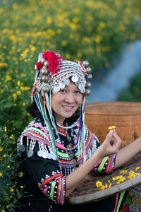 Full length of a smiling girl holding plant