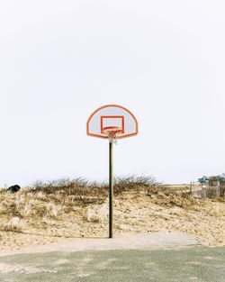 Basketball hoop at court against clear sky